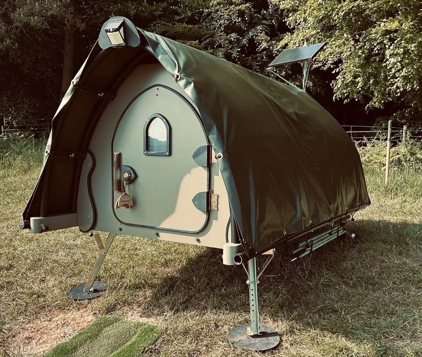 A landpod at Newhouse Farm with the awning extended and a solar panel on the roof