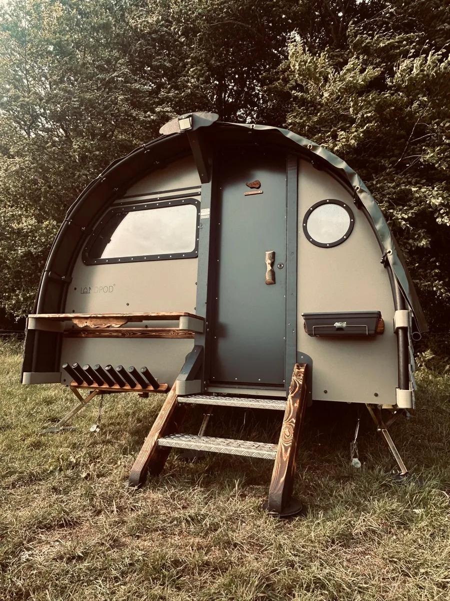 A landpod at Newhouse Farm, round porthole window beside the door