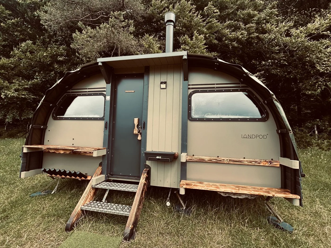 The Burrow landpod, wood stove flue on the roof and a fold-down kitchen shelf